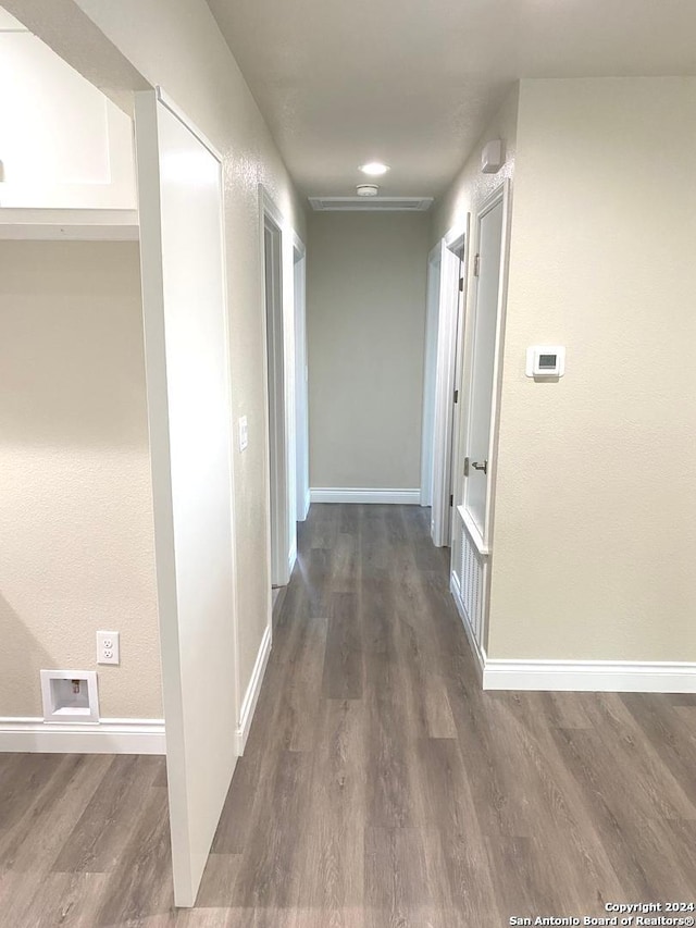 hallway featuring dark hardwood / wood-style flooring