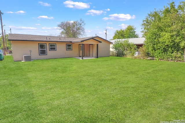 back of property featuring a patio, central AC, and a lawn