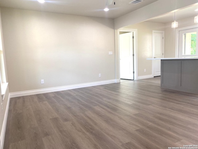 unfurnished living room with dark hardwood / wood-style floors