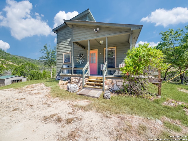 view of front of home featuring a mountain view and covered porch