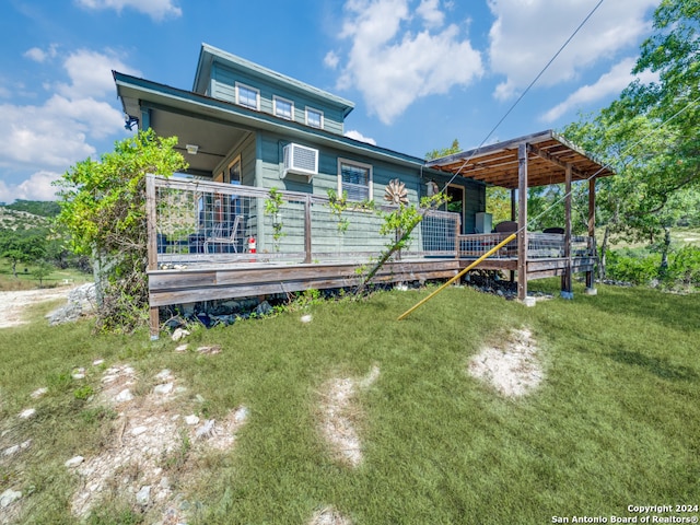 rear view of property with a wooden deck and a yard