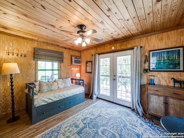 bedroom with multiple windows, wood ceiling, light wood-type flooring, and access to exterior