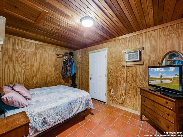 bedroom with wooden walls, tile patterned flooring, and wooden ceiling