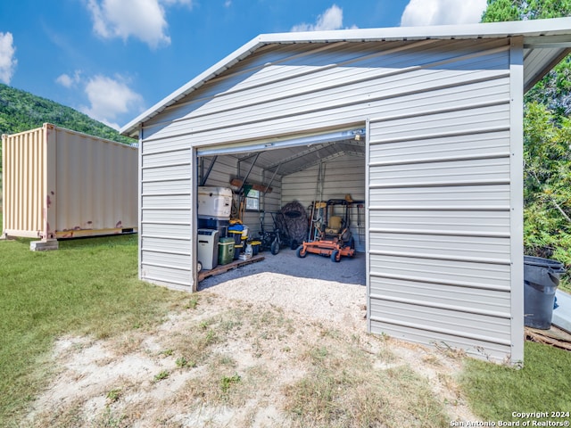 garage featuring a lawn