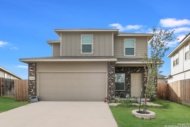 view of front of house featuring a garage and a front lawn