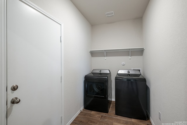 washroom featuring dark hardwood / wood-style floors and independent washer and dryer