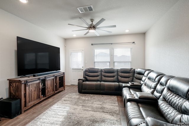 living room featuring ceiling fan and light hardwood / wood-style flooring