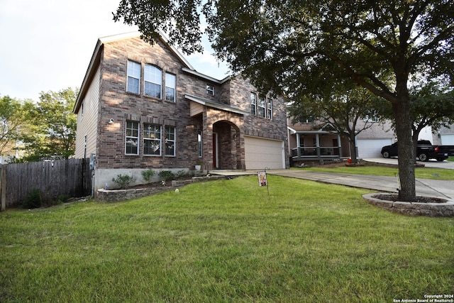 view of front of house with a front yard and a garage