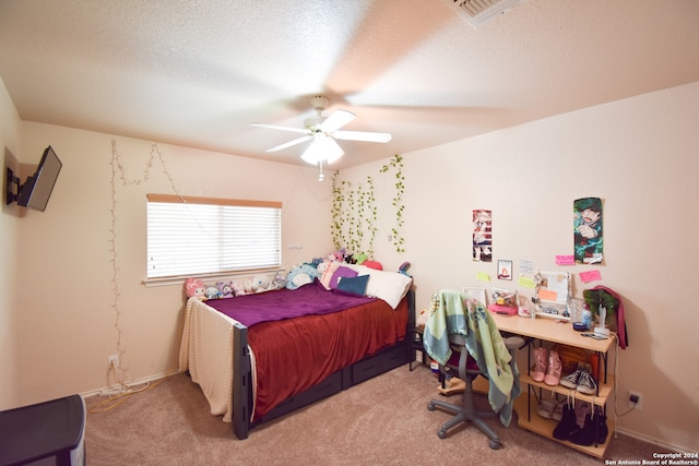 carpeted bedroom featuring a textured ceiling and ceiling fan