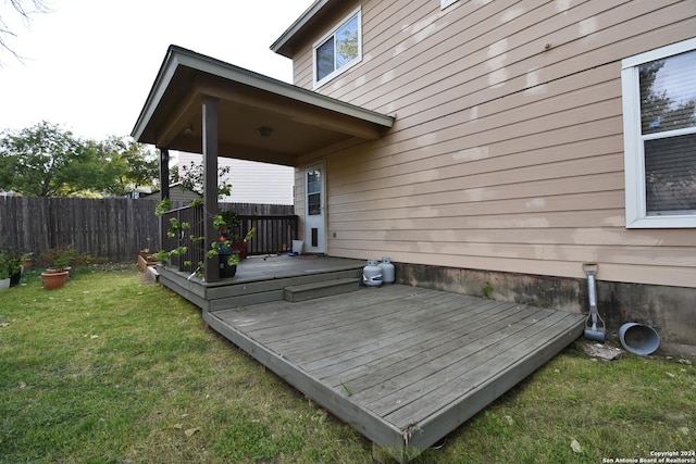 wooden deck featuring a yard