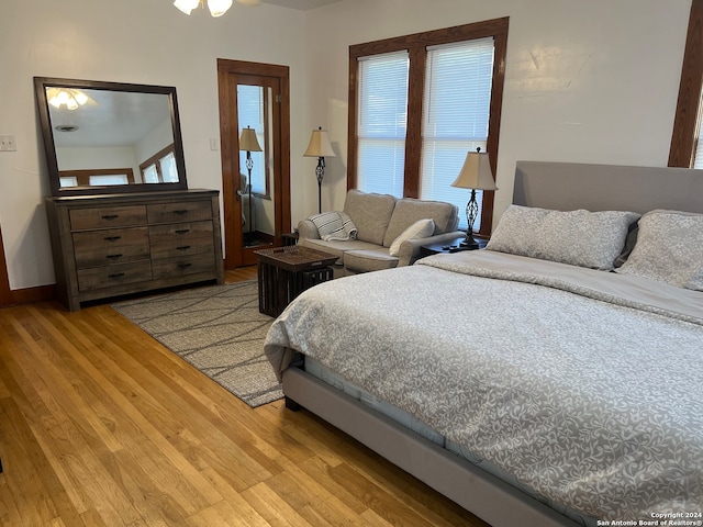 bedroom with multiple windows and light hardwood / wood-style floors