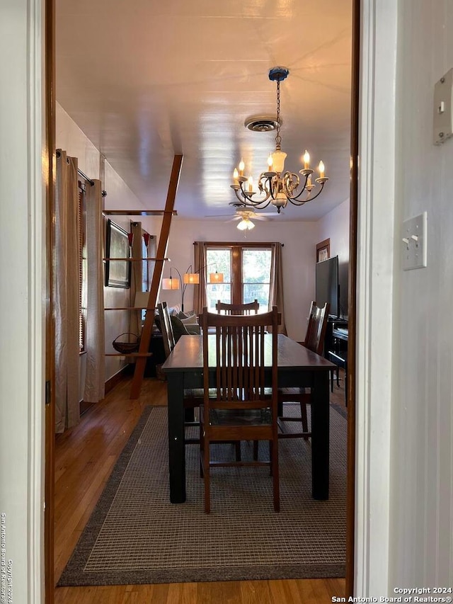 dining space featuring a chandelier and dark wood-type flooring