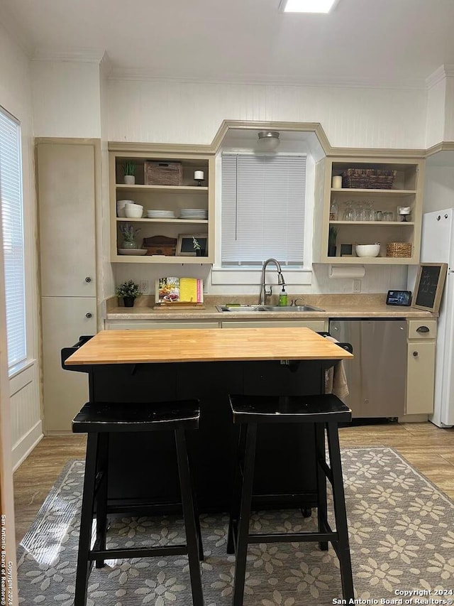 kitchen featuring white refrigerator, light wood-type flooring, wooden counters, and stainless steel dishwasher