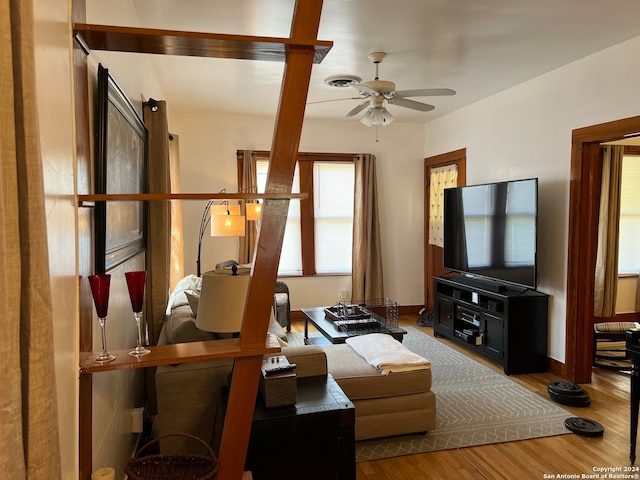 living room with wood-type flooring and ceiling fan