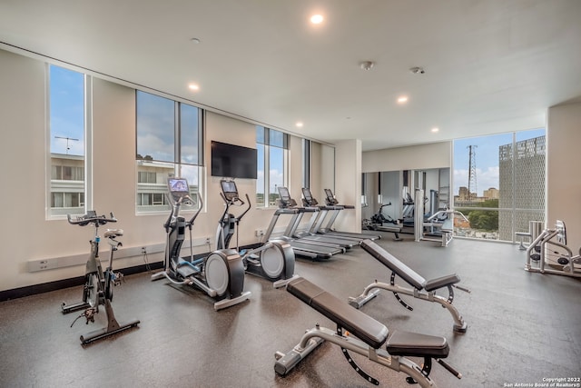 gym with a wall of windows