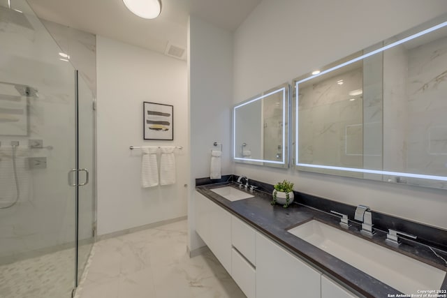 bathroom featuring vanity and a shower with door