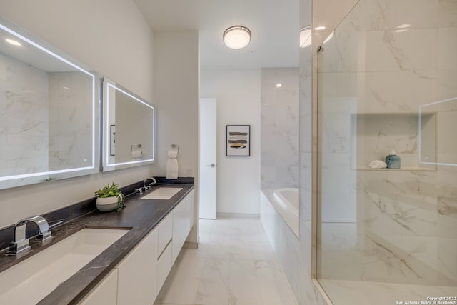 bathroom featuring vanity and shower with separate bathtub