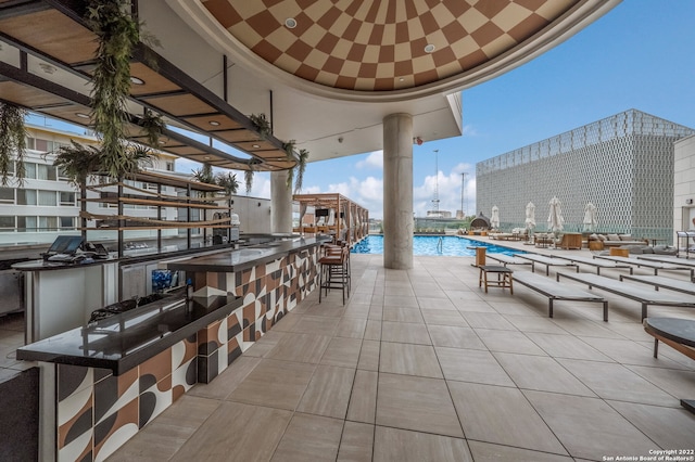 view of patio / terrace with an outdoor bar and a community pool