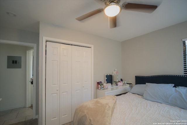 bedroom featuring a closet, ceiling fan, and electric panel