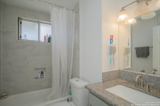 full bathroom with vanity, toilet, and shower / bath combo with shower curtain