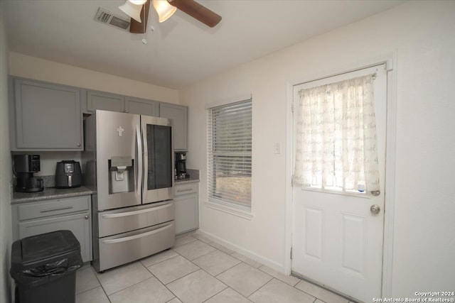 kitchen with gray cabinetry, ceiling fan, light tile patterned flooring, and stainless steel fridge with ice dispenser