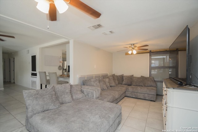 tiled living room with ceiling fan