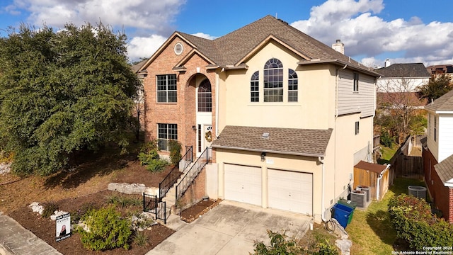 view of property with cooling unit and a garage