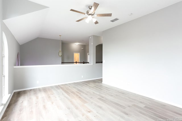 unfurnished room featuring light wood-type flooring, vaulted ceiling, and ceiling fan