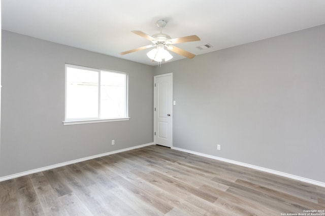 empty room featuring ceiling fan and light wood-type flooring