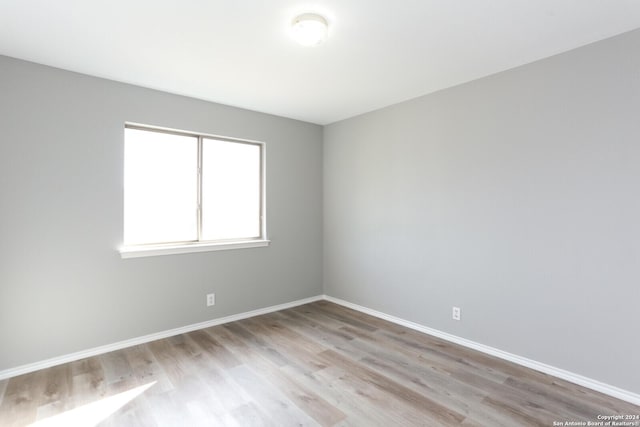 spare room with light hardwood / wood-style flooring