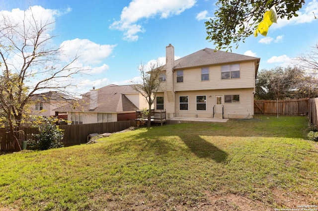 back of property featuring a lawn and a patio area