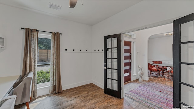 interior space with wood-type flooring and ceiling fan