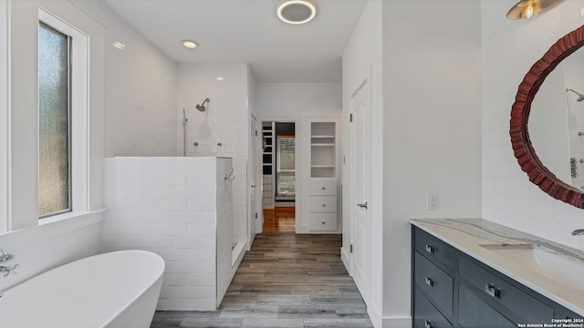 bathroom with separate shower and tub, hardwood / wood-style floors, and a wealth of natural light