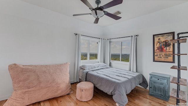 bedroom with light hardwood / wood-style floors and ceiling fan