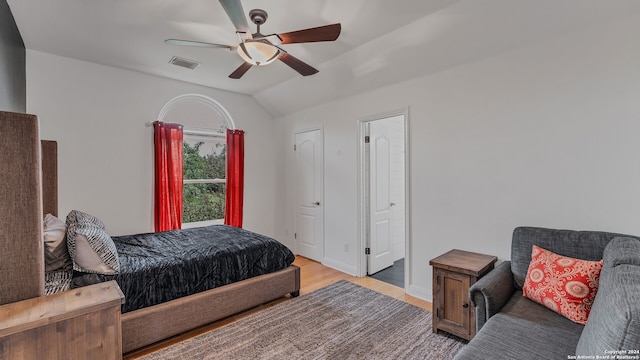 bedroom featuring ceiling fan, lofted ceiling, and light hardwood / wood-style floors