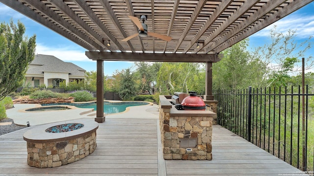 deck with a pergola, ceiling fan, a swimming pool with hot tub, and an outdoor fire pit