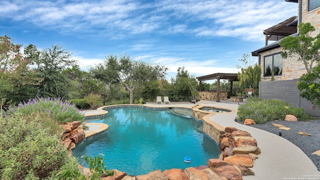 view of swimming pool with an in ground hot tub and a patio area