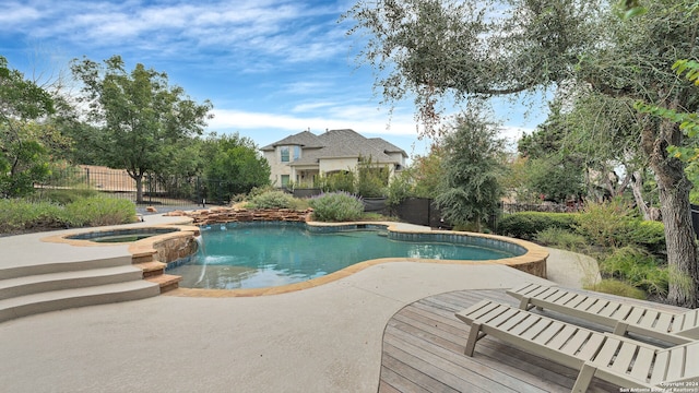 view of swimming pool with a patio and an in ground hot tub