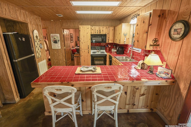 kitchen with white electric range oven, refrigerator, sink, kitchen peninsula, and tile countertops