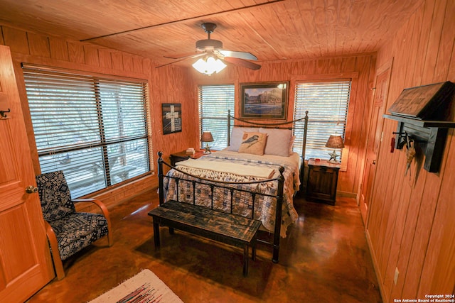 bedroom with wood walls, wooden ceiling, and ceiling fan