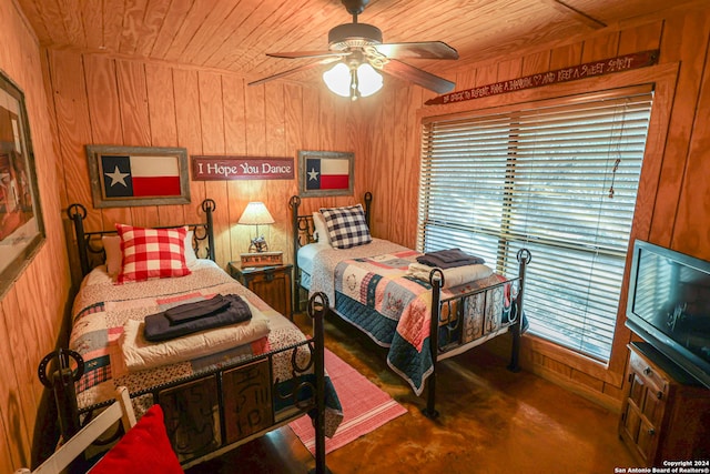 bedroom featuring dark colored carpet, wooden walls, ceiling fan, and wooden ceiling