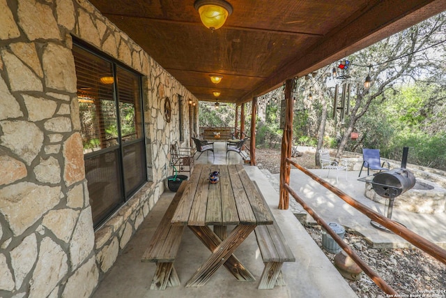 1177 River Rd, Concan, TX 78801 - wooden terrace with a fire pit and a patio