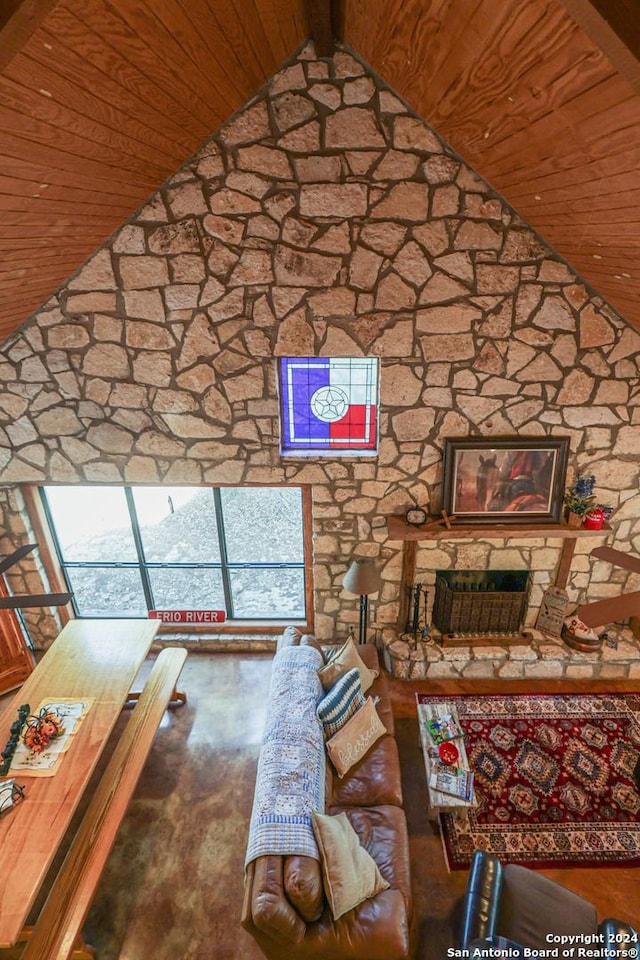 1177 River Rd, Concan, TX 78801 - unfurnished living room featuring wooden ceiling, lofted ceiling, and a stone fireplace