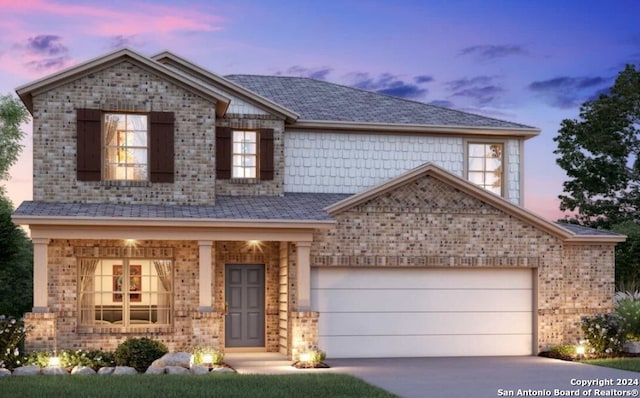 view of front of property with a garage and covered porch