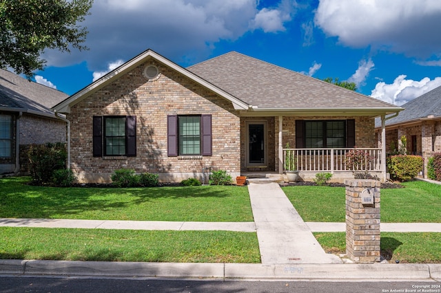 ranch-style house featuring a front yard and a porch