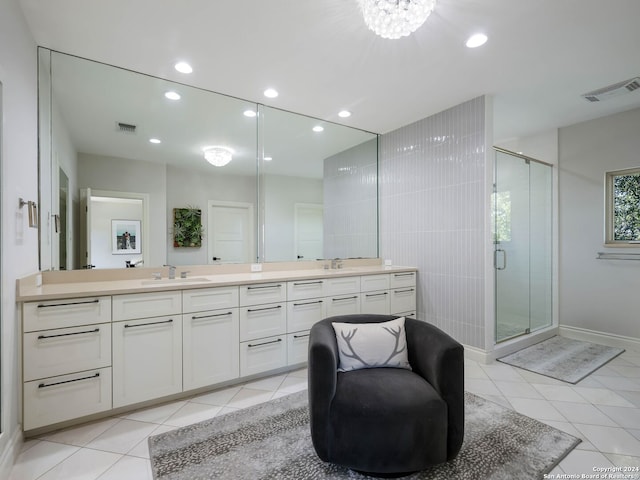 bathroom featuring vanity, tile patterned flooring, and a shower with shower door