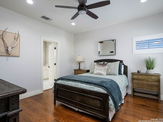 bedroom with ceiling fan, dark hardwood / wood-style floors, and ensuite bath