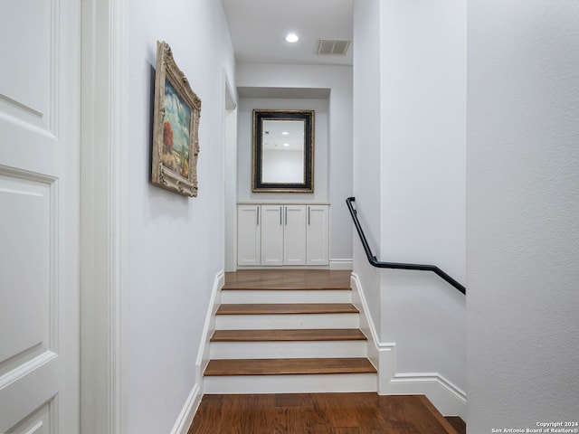 staircase featuring wood-type flooring