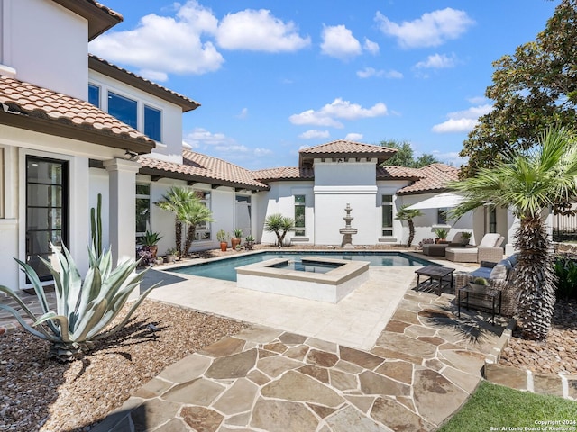 view of swimming pool featuring an outdoor hangout area, an in ground hot tub, and a patio area