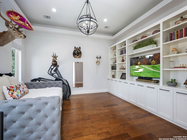 bedroom featuring dark hardwood / wood-style flooring and a chandelier